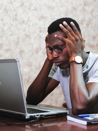 man stressed over laptop